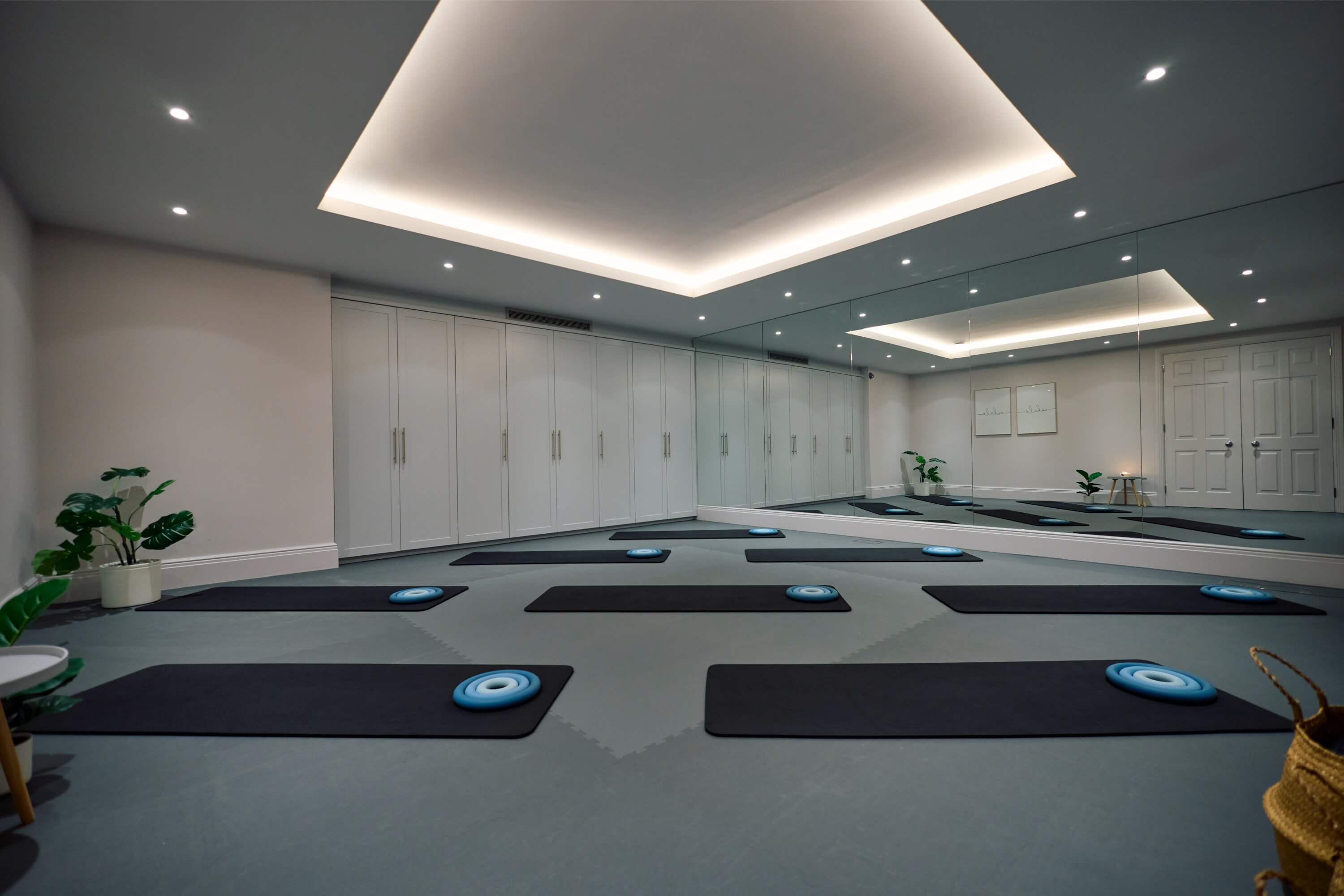 Image of a series of mats and pilates equipment lying on the floor on the Sam Deville Pilates studio in Wimbledon